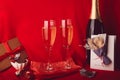 Aesthetics Valentines day background. Red seasonal romantic dinner with gift, postcard, champagne and chocolate candies