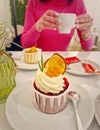 Aesthetics view with a carefree young woman in a cafe enjoys a cup of tea with cupcake Royalty Free Stock Photo