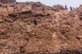 AFAR, ETHIOPIA - MARCH 26, 2019: Tourists climbing out of the Erta Ale volcano crater in Afar depression, Ethiop