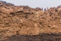 AFAR, ETHIOPIA - MARCH 26, 2019: Tourists climbing out of the Erta Ale volcano crater in Afar depression, Ethiop