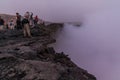 AFAR, ETHIOPIA - MARCH 26, 2019: Tourists at the edge of Erta Ale volcano crater in Afar depression, Ethiop