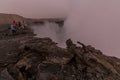 AFAR, ETHIOPIA - MARCH 26, 2019: Tourists at the edge of Erta Ale volcano crater in Afar depression, Ethiop