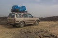 AFAR, ETHIOPIA - MARCH 25, 2019: Vehicle crossing lava fields on its way to Erta Ale volcano in Afar depression, Ethiop