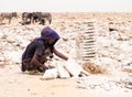 Afar man mining salt from salt flats in Afar region, Danakil Depression, Ethiopia.
