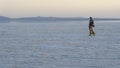 Afar soldier walking during sunset on the salt plains of Asale Lake in the Danakil Depression in Ethiopia, Africa