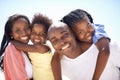 Affection brings them closer together. Two parents giving their children a piggyback while on the beach. Royalty Free Stock Photo