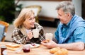 Affectionale elderly couple having coffee with toasts and jam for lunch in countryside Royalty Free Stock Photo