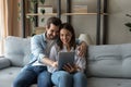 Affectionate bonding happy couple using digital tablet. Royalty Free Stock Photo