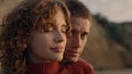 Affectionate couple posing at camera on beach. Lovely man embracing woman