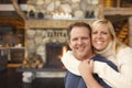 Affectionate Couple at Rustic Fireplace in Log Cabin Royalty Free Stock Photo