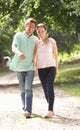 Affectionate Couple Walking In Countryside Togethe