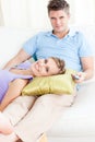 Affectionate couple watching television on sofa