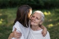 Affectionate granddaughter and grandmother are hugging. Happy together