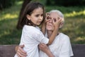 Affectionate granddaughter and grandmother are hugging. Happy together