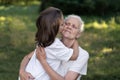 Affectionate granddaughter and grandmother are hugging. Happy together