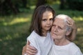 Affectionate granddaughter and grandmother are hugging. Happy together