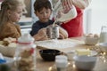 Affectionate children baking with their mother Royalty Free Stock Photo