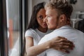 Affectionate lovely multiracial couple embracing with fondness