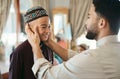 Affectionate, loving and caring Muslim father and son talking and bonding on Eid holiday. Cute, smiling and happy