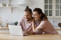 Affectionate loving millennial family couple using computer applications. Royalty Free Stock Photo