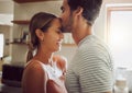 Affectionate, loving and romantic couple in a happy relationship together in the kitchen at home. Man and woman sharing Royalty Free Stock Photo