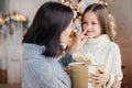 Affectionate mother gives present to her adorble little daughter Royalty Free Stock Photo