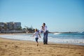 Affectionate mother playing with her little daughter on the beach Royalty Free Stock Photo