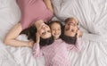 Affectionate Parents And Little Daughter Lying Together In Bed, Top View Royalty Free Stock Photo
