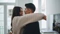 Affectionate people embracing at light kitchen closeup. Lovers enjoying cuddles