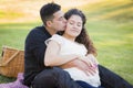 Affectionate Pregnant Hispanic Couple Kissing in The Park Outdoors Royalty Free Stock Photo