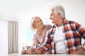 Affectionate senior couple with glasses of water at home Royalty Free Stock Photo