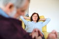 Affectionate senior couple in love sitting on sofa indoors at home, relaxing. Royalty Free Stock Photo