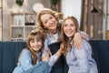 Affectionate two generations family looking at camera, posing for photo at home. Royalty Free Stock Photo