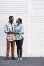 Smiling young African couple standing in the city together Royalty Free Stock Photo