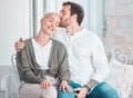 Affectionate young caucasian couple embracing while relaxing together at home. Happy boyfriend hugging and kissing Royalty Free Stock Photo