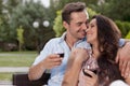 Affectionate young couple having red wine in park Royalty Free Stock Photo