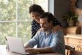 Affectionate young family couple using computer at home. Royalty Free Stock Photo