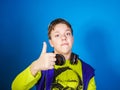 Affective teenage boy listening music in headphones Royalty Free Stock Photo