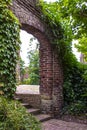 Afferden, Limburg, Netherlands - May 20, 2020: Old overgrown entrance gate as entrance to the local cemetery