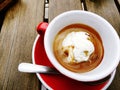 An affogato (hot espresso coffee poured over ice-cream), served in red cup and saucer Royalty Free Stock Photo