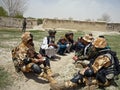 Afghan military officer interrogating locals