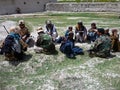 Afghan military officer interrogating locals