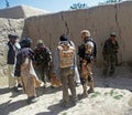 Afghan military officer interrogating locals