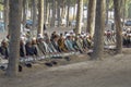 Afghan Muslim men assemble in quiet, kneeling to pray