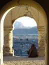 An Afghan muslim sits in an archway overlooking Kabul in damaged tomb of Sultan Sultan Mohammed Khan Telai, former king of