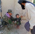 Afghan officer playing with a children in Afghanistan Royalty Free Stock Photo