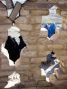 Afghan women in burqas seen through old wall