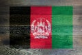 Afghanistan flag on rustic old wood surface background Royalty Free Stock Photo