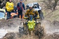 Sportsmen on BRP Can-Am quad bikes drive splashing in dirt and water at Mud Racing contest. ATV SSV motobike competitions are Royalty Free Stock Photo