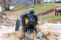 Sportsmen on BRP Can-Am quad bikes drive splashing in dirt and water at Mud Racing contest. ATV SSV motobike competitions are Royalty Free Stock Photo